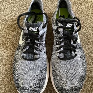 Womens Nike Free RN Flyknit running shoes, black and white, size 7.